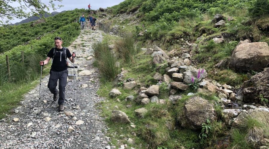 group hiking down a mountain path