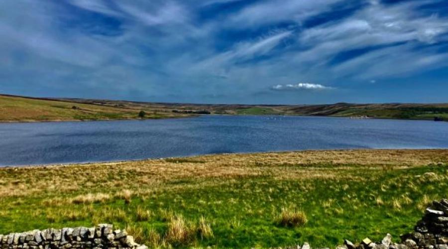Reservoir view with cloudy sky above
