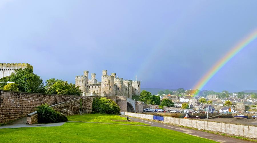 Conwy Castle with a rainbow behind