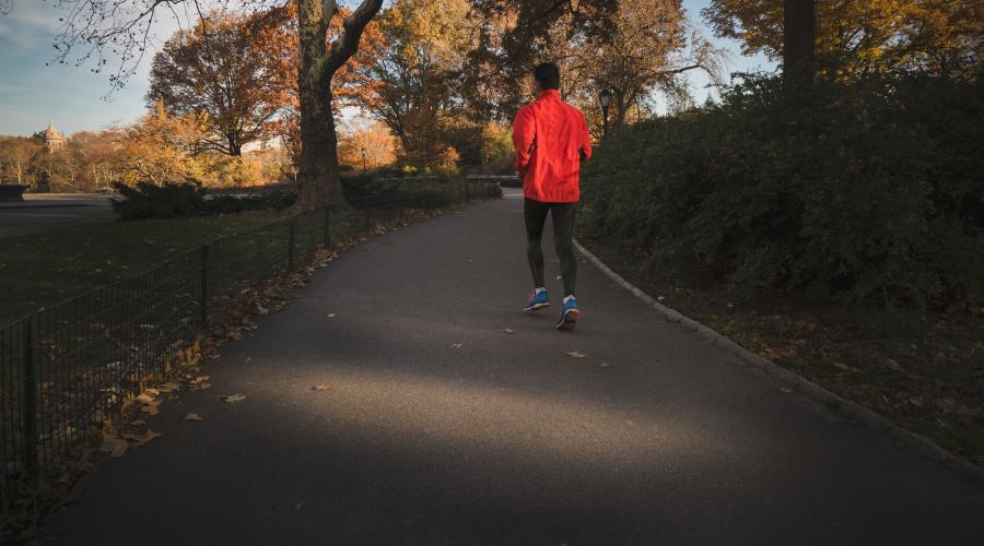 Image of a man running though a park