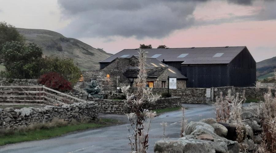 Autumn colours at wide waterfall , blue sky above