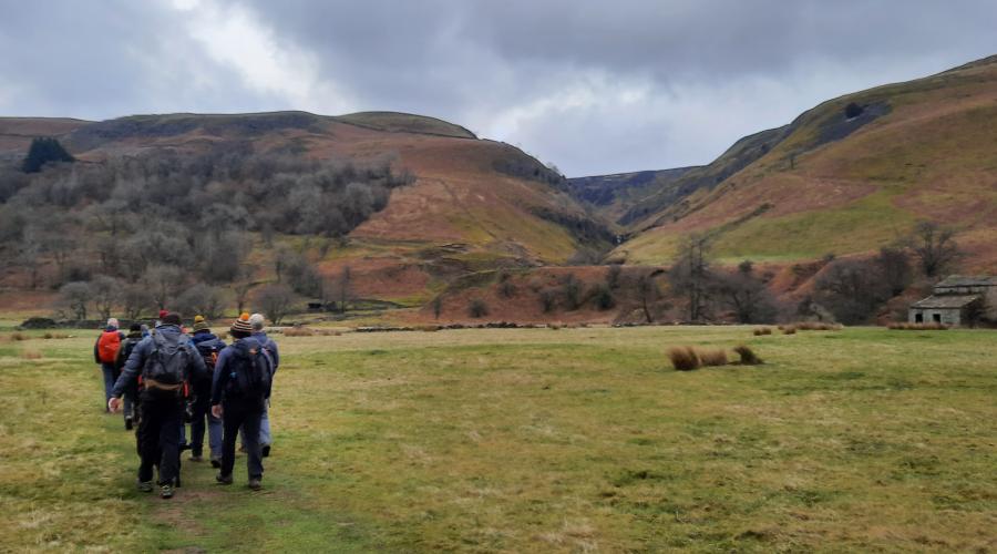 Autumn colours at wide waterfall , blue sky above