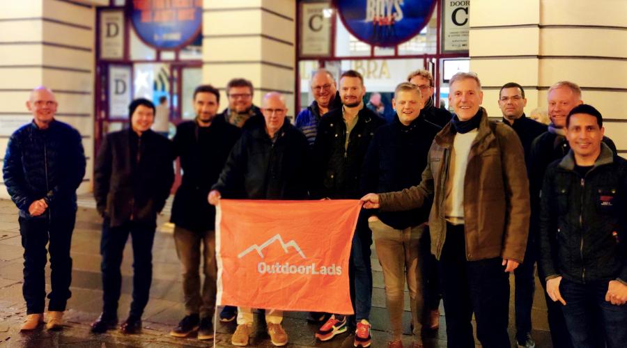 An event at Bingley Little Theatre showing people seated at tables and getting refreshments next to a pop up banner