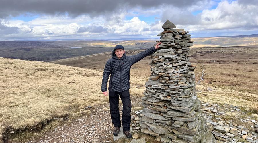 Autumn colours at wide waterfall , blue sky above