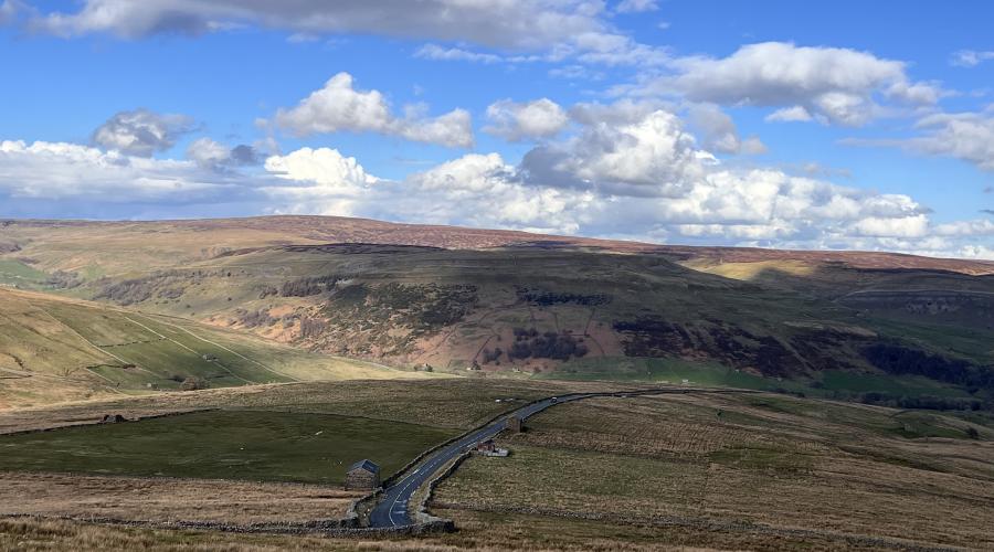 Autumn colours at wide waterfall , blue sky above