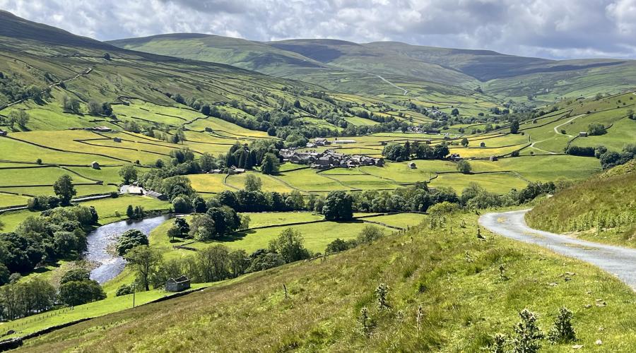 Autumn colours at wide waterfall , blue sky above