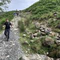 group hiking down a mountain path