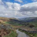 Autumn colours at wide waterfall , blue sky above