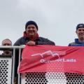 Outdoorlads members with red flag on the bridge into Bingley