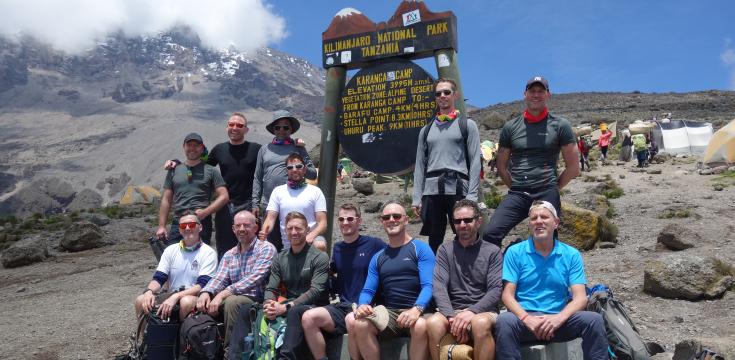 OutdoorLads & Pride Expeditions at a Kilimanjaro camp sign